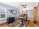Bright home office featuring hardwood floors, a ceiling fan, and barn door access at 2687 E 124Th Pl, Thornton, CO 80241