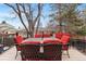 Outdoor patio with a dark metal table and seating, surrounded by mature trees and neighborhood views at 2687 E 124Th Pl, Thornton, CO 80241