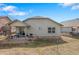 Enjoy outdoor dining on the patio, with access to the yard through sliding glass doors at 157 Sand Cherry St, Brighton, CO 80601