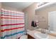 Bathroom with a vanity, colorful striped shower curtain, and neutral walls at 157 Sand Cherry St, Brighton, CO 80601