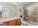 Bathroom with tiled shower, glass door, neutral walls and wood vanity at 157 Sand Cherry St, Brighton, CO 80601