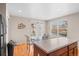 Kitchen area with a glass-top dining table and chairs next to a light-filled window at 157 Sand Cherry St, Brighton, CO 80601