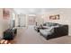 Bright living room with natural light, plush carpet, and a comfortable seating area at 157 Sand Cherry St, Brighton, CO 80601