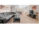 Open-concept living room with neutral tones seamlessly connects to dining and kitchen at 157 Sand Cherry St, Brighton, CO 80601