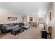 Open-concept living room with neutral tones seamlessly connects to dining and kitchen at 157 Sand Cherry St, Brighton, CO 80601