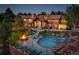 Luxurious backyard featuring a pool, fire pit, lounge chairs, and lush landscaping at 5 Walden Ln, Cherry Hills Village, CO 80121