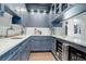 Stylish bar area featuring custom blue cabinetry, granite countertops, and a wine cooler at 5 Walden Ln, Cherry Hills Village, CO 80121