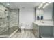 Bathroom featuring a walk-in shower with a seat, vanity with sink, and tiled floor at 5 Walden Ln, Cherry Hills Village, CO 80121