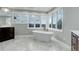 Bright bathroom featuring a soaking tub with mountain views from large windows at 5 Walden Ln, Cherry Hills Village, CO 80121