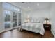 Bright bedroom with wood floors and access to the outdoors through glass doors at 5 Walden Ln, Cherry Hills Village, CO 80121