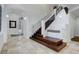Grand foyer features a staircase with a built-in bench and stone tile flooring at 5 Walden Ln, Cherry Hills Village, CO 80121