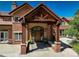 Grand front entrance with a covered porch, brick pillars, and a stone pathway at 5 Walden Ln, Cherry Hills Village, CO 80121