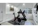 Home gym featuring an exercise bike, treadmill, carpet flooring, and natural light at 5 Walden Ln, Cherry Hills Village, CO 80121