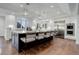 Modern kitchen featuring a large island with seating, stainless steel appliances, and hardwood floors at 5 Walden Ln, Cherry Hills Village, CO 80121