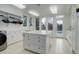 Bright laundry room with ample counter space, storage cabinets, and a washer/dryer at 5 Walden Ln, Cherry Hills Village, CO 80121