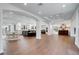 Bright, open-concept living area with hardwood floors, large arches, and white trim at 5 Walden Ln, Cherry Hills Village, CO 80121