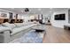 Spacious living room featuring a large sectional sofa, hardwood floors, and a cozy area rug at 5 Walden Ln, Cherry Hills Village, CO 80121