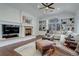 Comfortable living room featuring a fireplace, custom bookshelves, and large windows at 5 Walden Ln, Cherry Hills Village, CO 80121