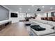 Spacious living room with a large sectional sofa, hardwood floors, and a media center at 5 Walden Ln, Cherry Hills Village, CO 80121