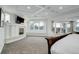 Bright main bedroom with a fireplace and a window offering scenic views at 5 Walden Ln, Cherry Hills Village, CO 80121