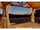 Scenic outdoor view from covered porch with curtains and metal railing at 5 Walden Ln, Cherry Hills Village, CO 80121