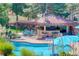Inviting backyard featuring a sparkling pool, covered outdoor kitchen, and dining area, perfect for enjoying outdoor living at 5 Walden Ln, Cherry Hills Village, CO 80121