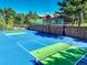 Well-maintained tennis court featuring lush landscaping and nearby cabana at 5 Walden Ln, Cherry Hills Village, CO 80121