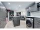 Spacious walk-in closet with custom shelving, drawers, and a washer/dryer unit at 5 Walden Ln, Cherry Hills Village, CO 80121