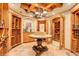 Elegant wine cellar with custom wood racks, stone floors, and beautiful lighting at 5 Walden Ln, Cherry Hills Village, CO 80121