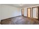 Bedroom featuring comfortable carpet, electrical outlets, neutral walls, and convenient access to closets and bathroom at 17381 E Mansfield Ave # 711L, Aurora, CO 80013