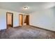 Bedroom with soft carpet, multiple closets, neutral walls, and electrical outlets, allowing comfort and functionality at 17381 E Mansfield Ave # 711L, Aurora, CO 80013