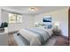 Comfortable bedroom with a large window, modern decor, carpet, and a serene color palette at 17381 E Mansfield Ave # 711L, Aurora, CO 80013