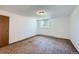 Bright bedroom with plush carpeting, a sun-filled window, and radiator, creating a cozy and comfortable retreat at 17381 E Mansfield Ave # 711L, Aurora, CO 80013