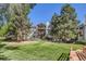 Condo building with multiple balconies surrounded by lush greenery and trees at 17381 E Mansfield Ave # 711L, Aurora, CO 80013