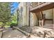A view of a home's wood-sided exterior with stairs leading up to a balcony at 17381 E Mansfield Ave # 711L, Aurora, CO 80013