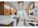 Functional kitchen featuring oak cabinets, modern white appliances, and ample countertop space for easy meal preparation at 17381 E Mansfield Ave # 711L, Aurora, CO 80013