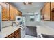 Functional kitchen area with essential appliances and seamless flow into the living space, enhancing convenience and connectivity at 17381 E Mansfield Ave # 711L, Aurora, CO 80013