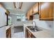 Charming kitchen with oak cabinets, tile flooring, and a convenient sink with countertop for food preparation at 17381 E Mansfield Ave # 711L, Aurora, CO 80013