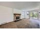 Living room features stone fireplace and sliding door leading to outdoor area at 17381 E Mansfield Ave # 711L, Aurora, CO 80013