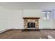 Living room boasts a stone fireplace, carpet flooring, and large window at 17381 E Mansfield Ave # 711L, Aurora, CO 80013