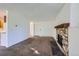 Open living room showcasing stone fireplace and access to dining area at 17381 E Mansfield Ave # 711L, Aurora, CO 80013