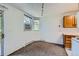 Bright living area showcasing neutral carpeting, an AC unit, and a clear view, creating a comfortable living environment at 17381 E Mansfield Ave # 711L, Aurora, CO 80013