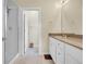 Bathroom featuring a glass shower, white cabinets, and a large mirror at 18059 French Creek Ave, Parker, CO 80134