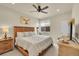 Cozy bedroom with a rustic wood bed frame, ceiling fan, and natural light at 18059 French Creek Ave, Parker, CO 80134