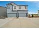 Modern townhome exterior with two-car garages and contemporary design, set against a clear blue sky at 18059 French Creek Ave, Parker, CO 80134