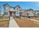 Inviting two-story home with a red front door, a welcoming porch, and a beautifully landscaped front yard at 18059 French Creek Ave, Parker, CO 80134