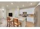 Bright kitchen featuring a large center island with seating, stainless steel appliances, and sleek white cabinetry at 18059 French Creek Ave, Parker, CO 80134