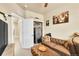 Living room with a leather couch, gun safe, and a doorway to another room at 18059 French Creek Ave, Parker, CO 80134