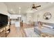 Spacious open-concept featuring a modern kitchen with white cabinets, dining area, and comfortable living space at 18059 French Creek Ave, Parker, CO 80134