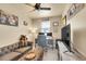 Home office with dual monitors, brown leather couch, and ceiling fan at 18059 French Creek Ave, Parker, CO 80134